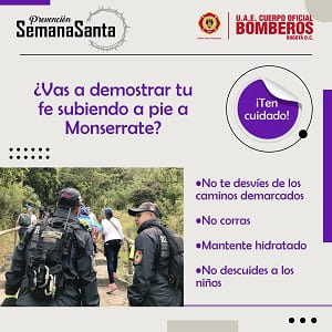 bomberos acompañan a personas en el sendero de Monserrate