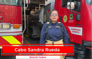 Bombera en medio de dos camiones de bomberos 